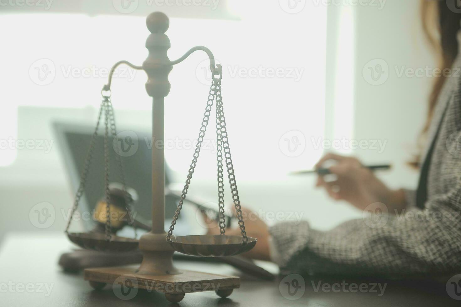 Business and lawyers discussing contract papers with brass scale on desk in office. Law, legal services, advice, justice and law concept picture with film grain effect photo