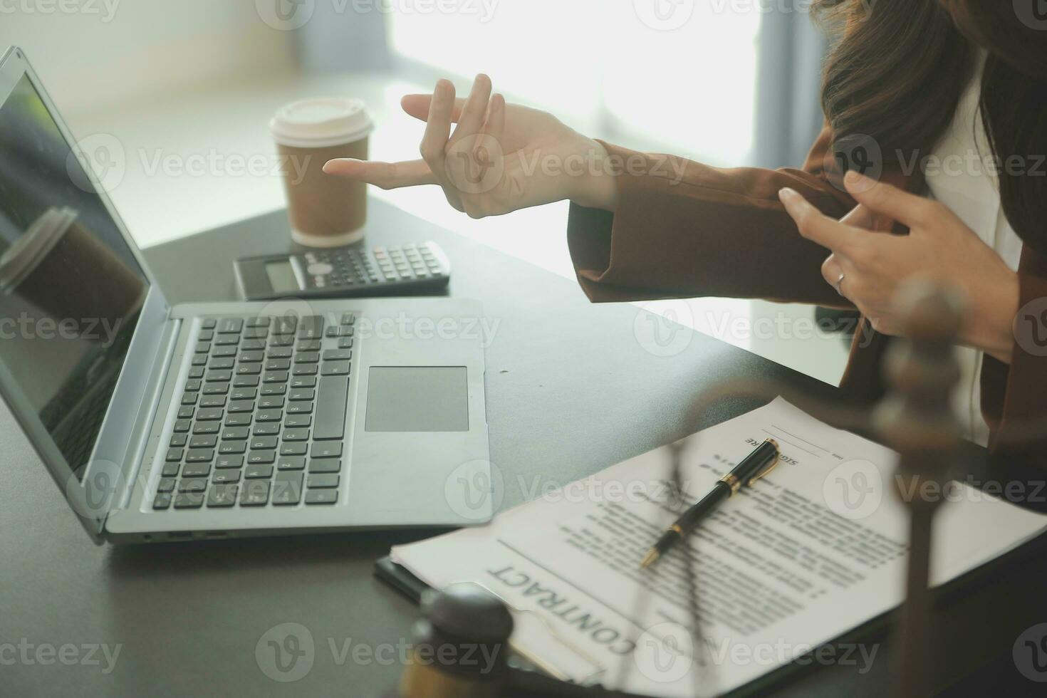Business and lawyers discussing contract papers with brass scale on desk in office. Law, legal services, advice, justice and law concept picture with film grain effect photo