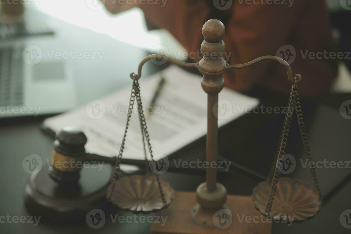Business and lawyers discussing contract papers with brass scale on desk in office. Law, legal services, advice, justice and law concept picture with film grain effect photo