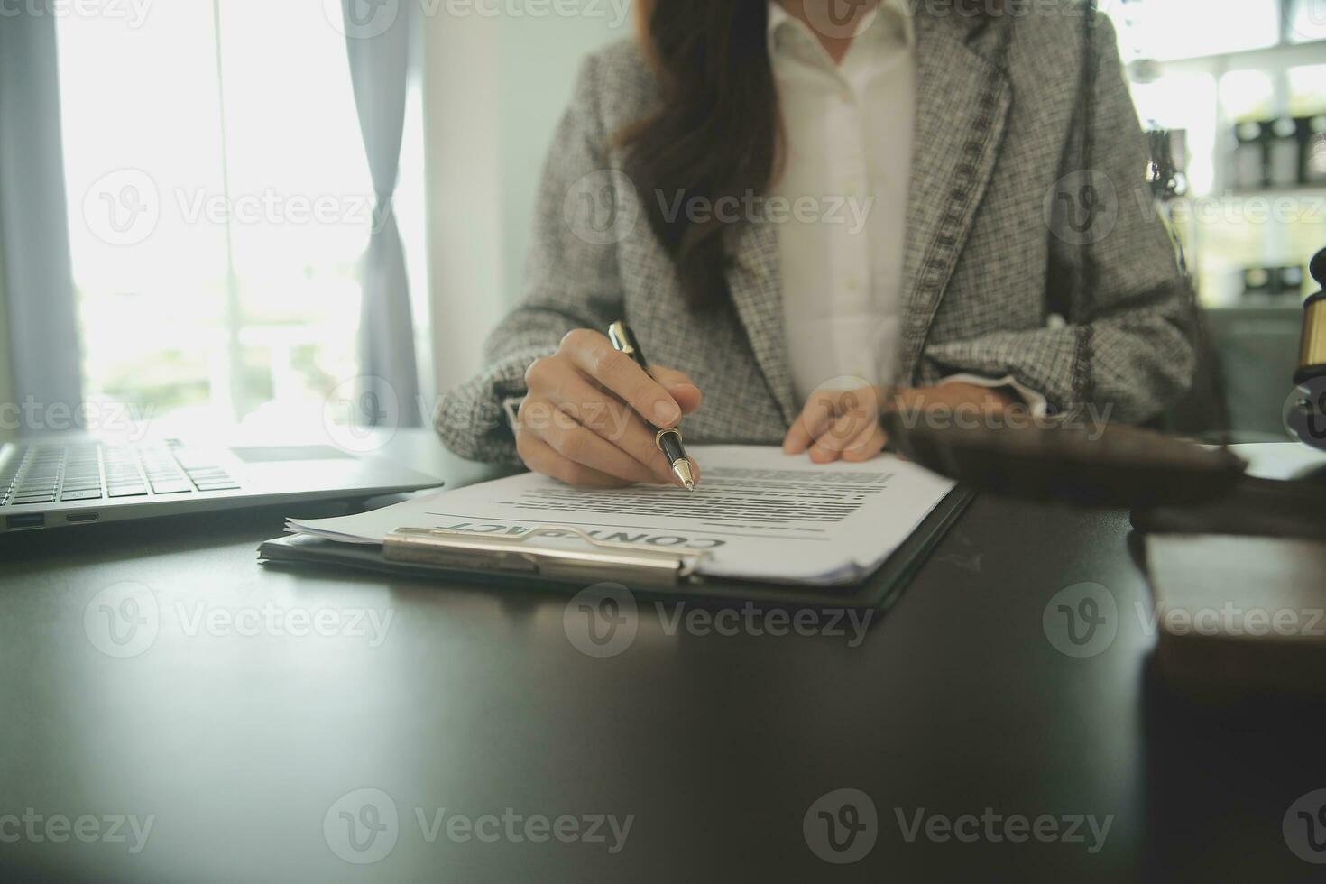 Business and lawyers discussing contract papers with brass scale on desk in office. Law, legal services, advice, justice and law concept picture with film grain effect photo