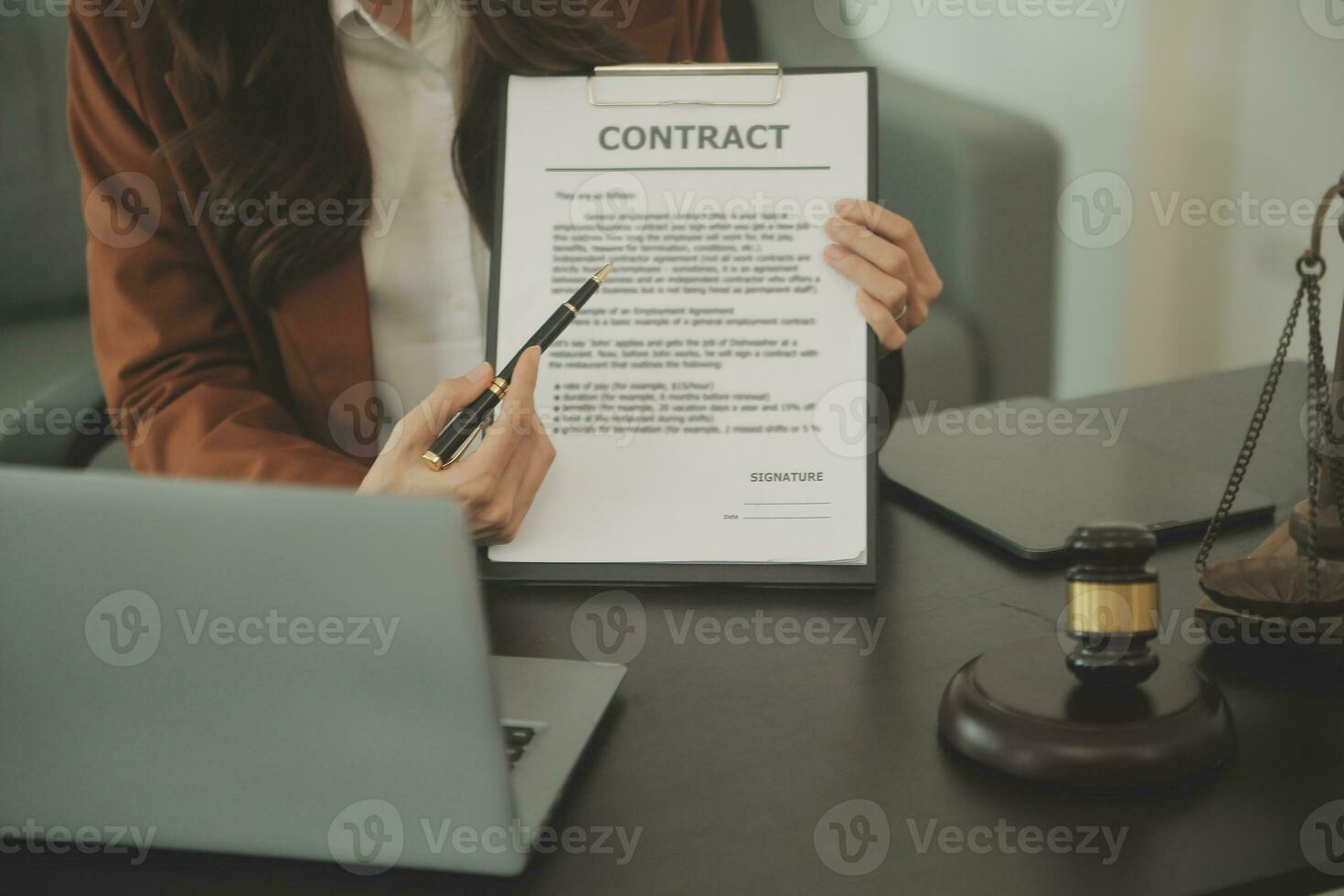 Business and lawyers discussing contract papers with brass scale on desk in office. Law, legal services, advice, justice and law concept picture with film grain effect photo