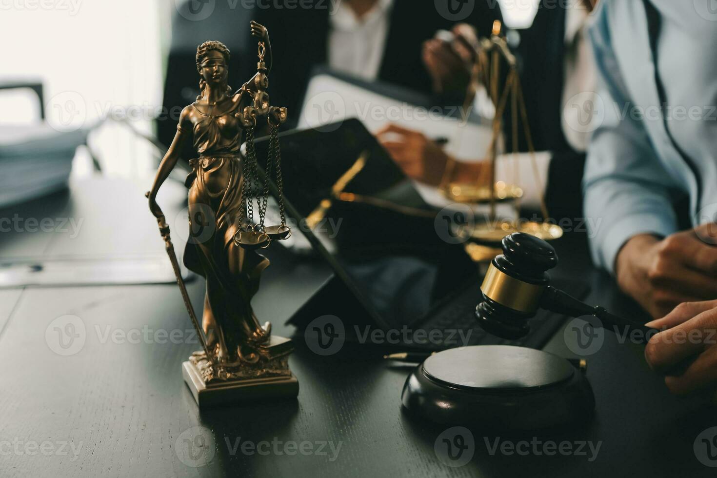 Business and lawyers discussing contract papers with brass scale on desk in office. Law, legal services, advice, justice and law concept picture with film grain effect photo