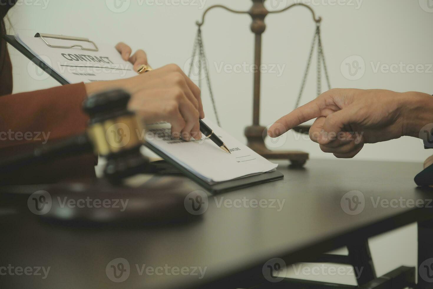 Business and lawyers discussing contract papers with brass scale on desk in office. Law, legal services, advice, justice and law concept picture with film grain effect photo
