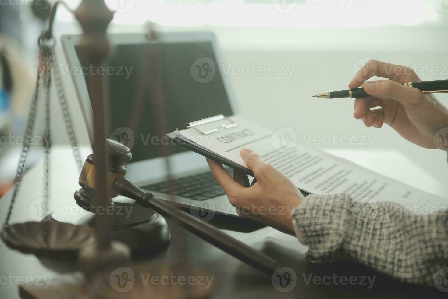 Business and lawyers discussing contract papers with brass scale on desk in office. Law, legal services, advice, justice and law concept picture with film grain effect photo