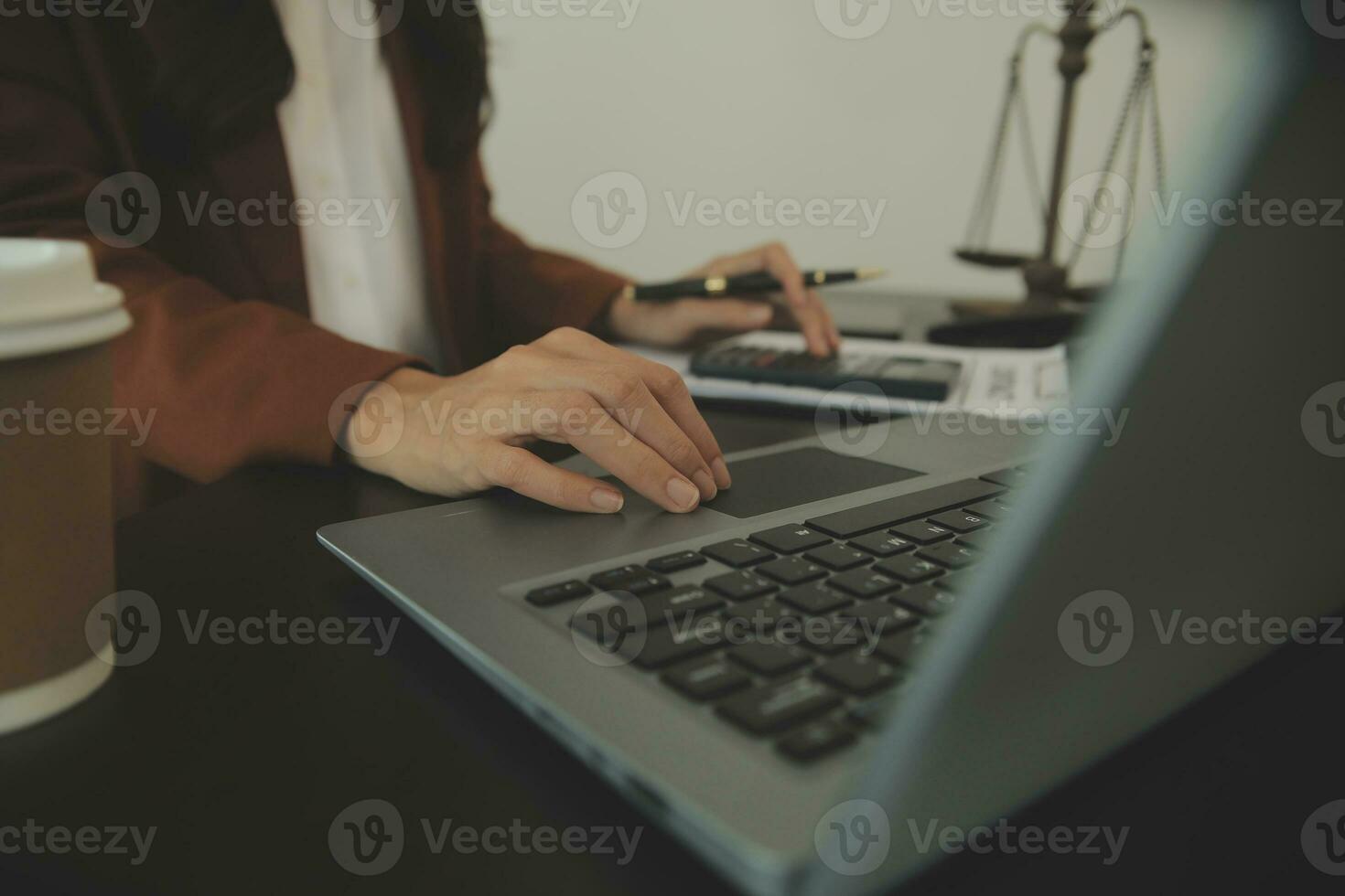 Business and lawyers discussing contract papers with brass scale on desk in office. Law, legal services, advice, justice and law concept picture with film grain effect photo