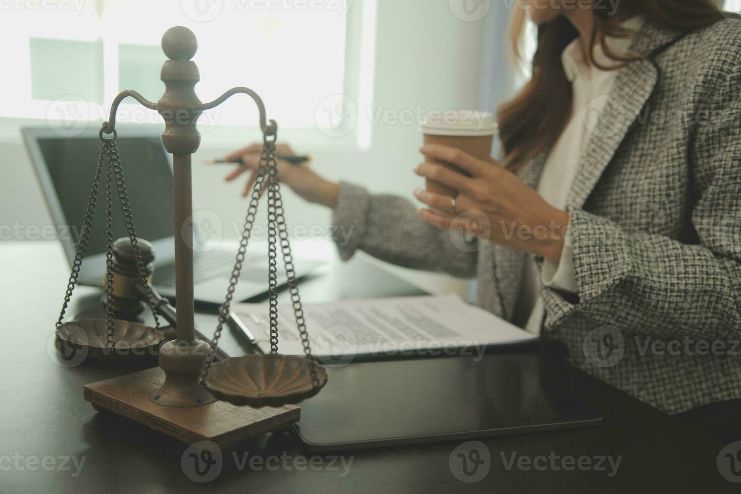 Business and lawyers discussing contract papers with brass scale on desk in office. Law, legal services, advice, justice and law concept picture with film grain effect photo