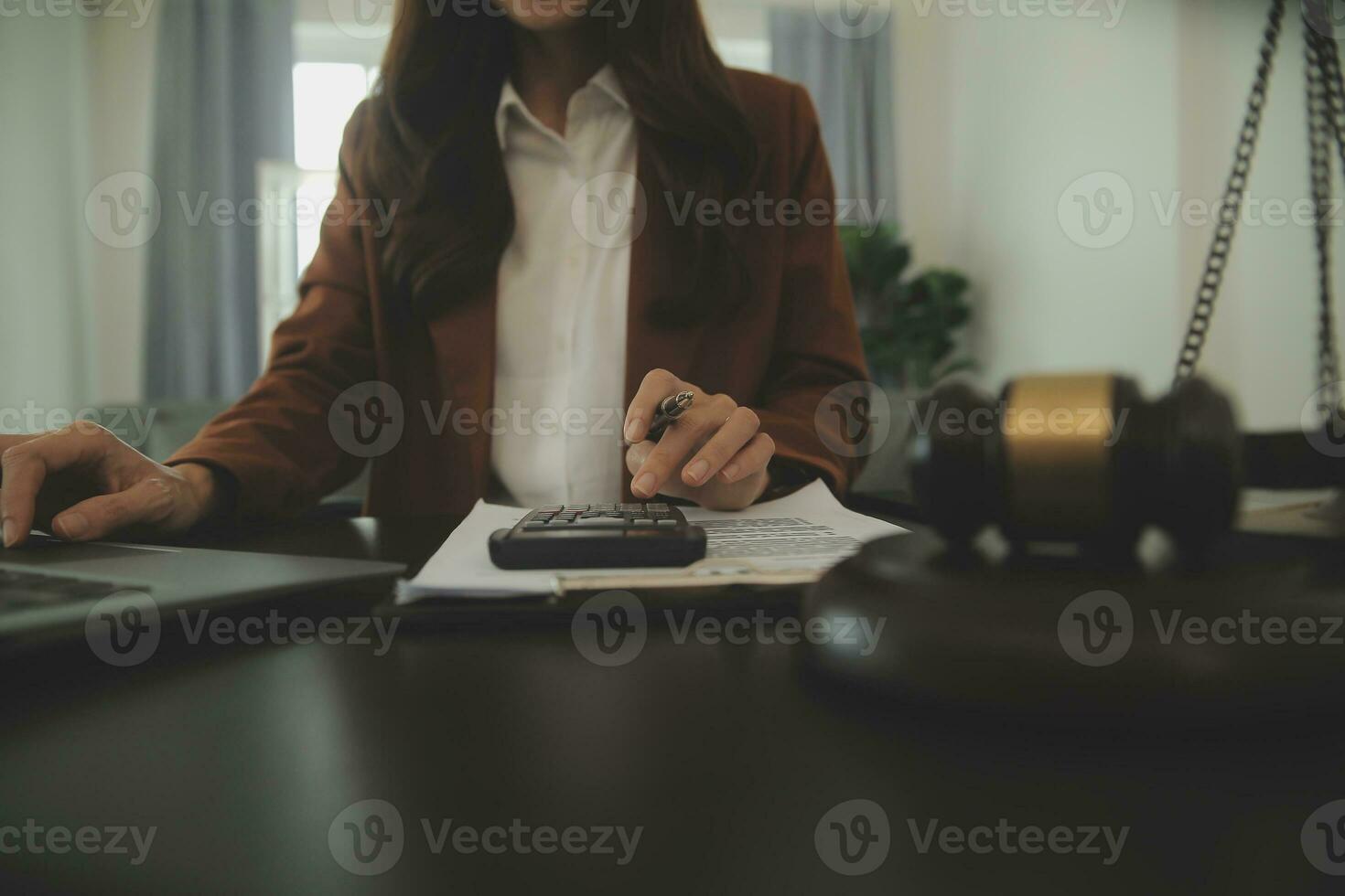 Business and lawyers discussing contract papers with brass scale on desk in office. Law, legal services, advice, justice and law concept picture with film grain effect photo
