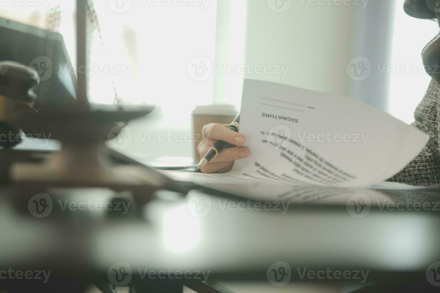 Business and lawyers discussing contract papers with brass scale on desk in office. Law, legal services, advice, justice and law concept picture with film grain effect photo