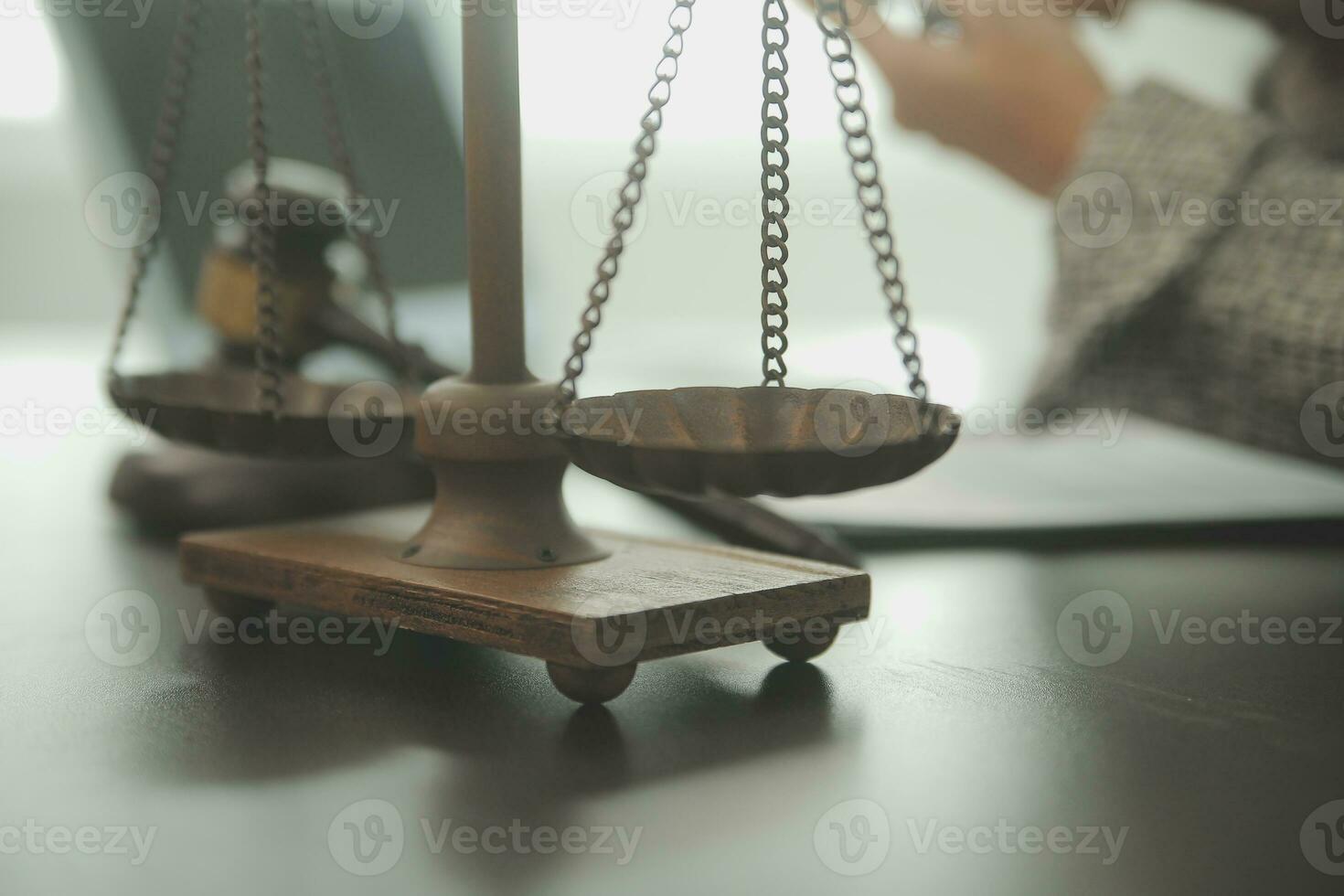 Business and lawyers discussing contract papers with brass scale on desk in office. Law, legal services, advice, justice and law concept picture with film grain effect photo
