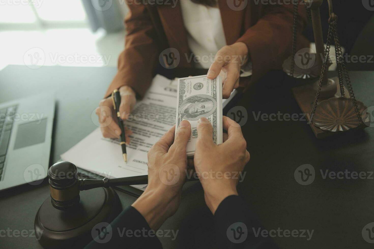 Business and lawyers discussing contract papers with brass scale on desk in office. Law, legal services, advice, justice and law concept picture with film grain effect photo