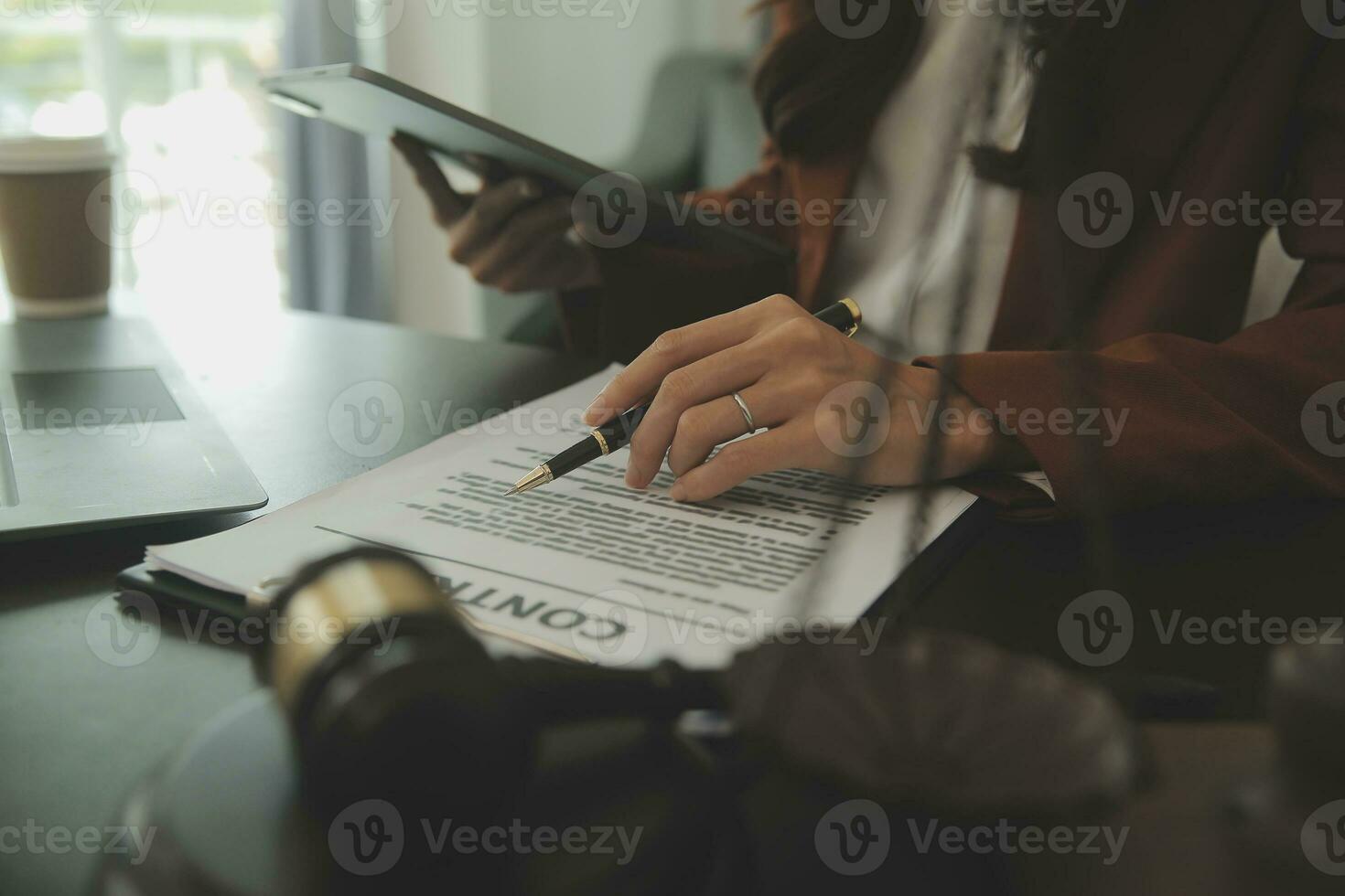 Business and lawyers discussing contract papers with brass scale on desk in office. Law, legal services, advice, justice and law concept picture with film grain effect photo