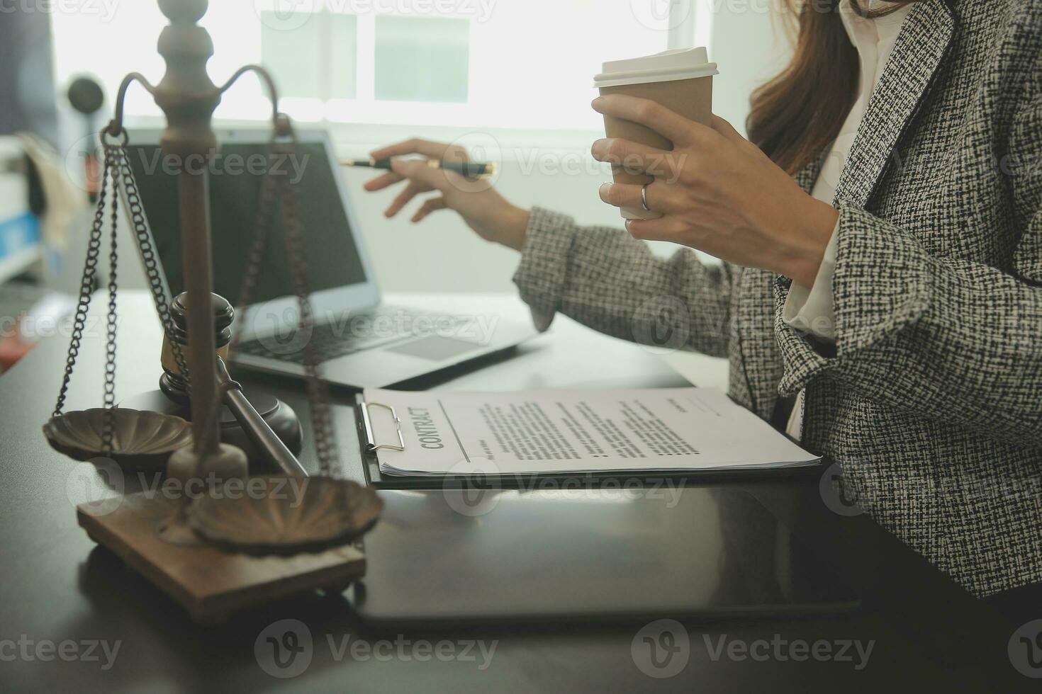 Business and lawyers discussing contract papers with brass scale on desk in office. Law, legal services, advice, justice and law concept picture with film grain effect photo