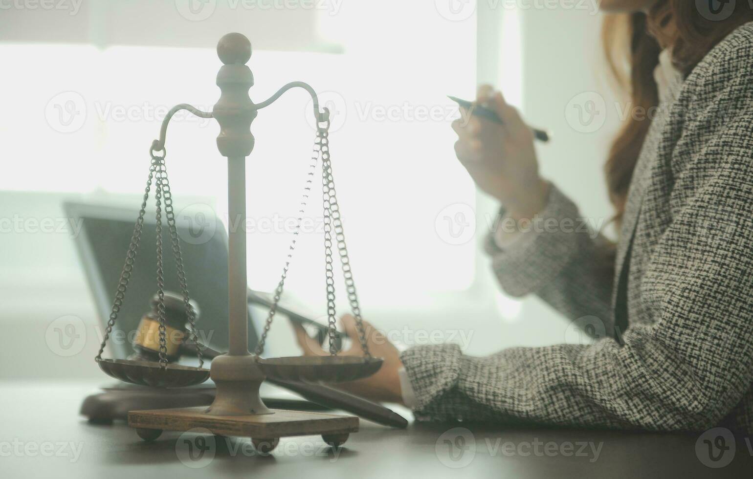 Business and lawyers discussing contract papers with brass scale on desk in office. Law, legal services, advice, justice and law concept picture with film grain effect photo