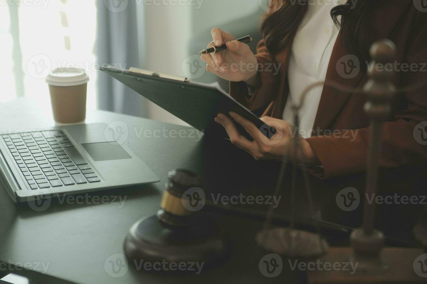 Business and lawyers discussing contract papers with brass scale on desk in office. Law, legal services, advice, justice and law concept picture with film grain effect photo