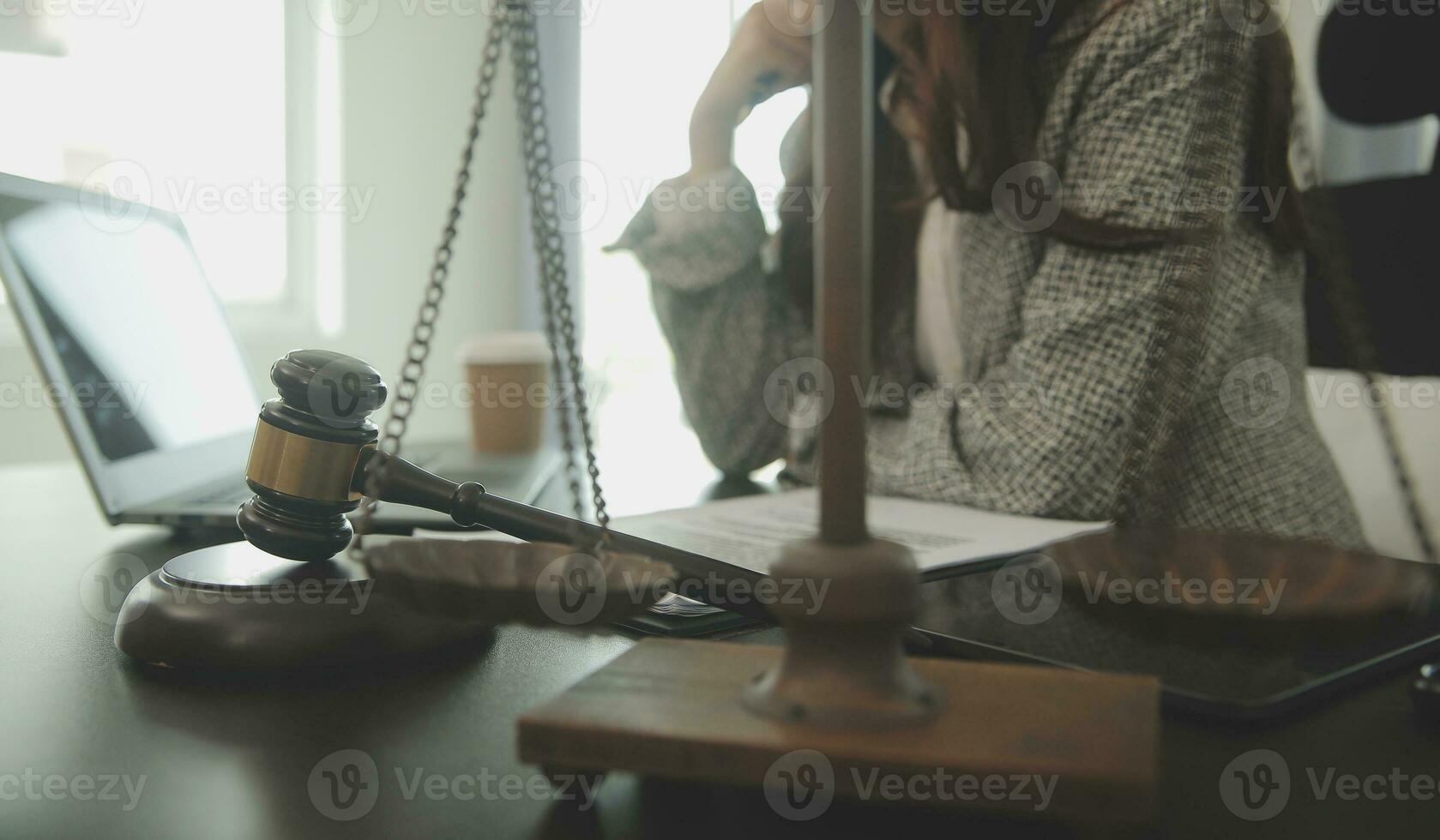 Business and lawyers discussing contract papers with brass scale on desk in office. Law, legal services, advice, justice and law concept picture with film grain effect photo