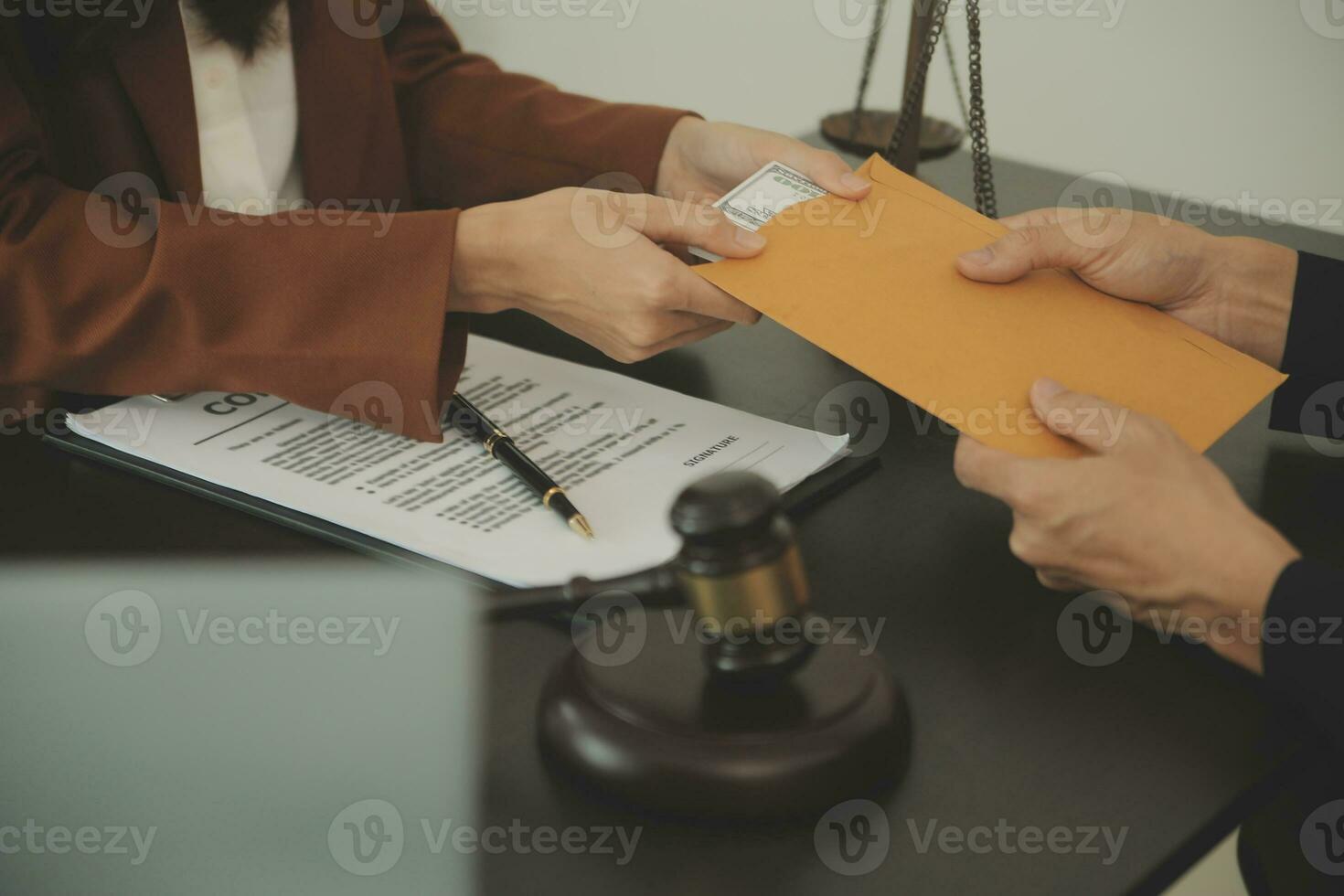 Business and lawyers discussing contract papers with brass scale on desk in office. Law, legal services, advice, justice and law concept picture with film grain effect photo