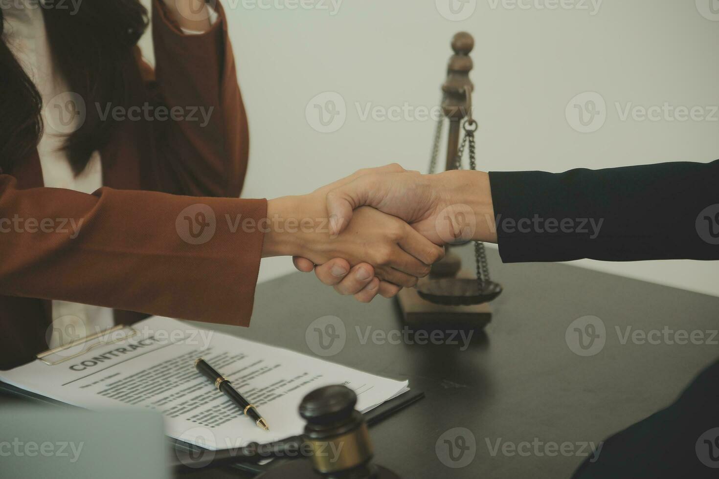 Business and lawyers discussing contract papers with brass scale on desk in office. Law, legal services, advice, justice and law concept picture with film grain effect photo