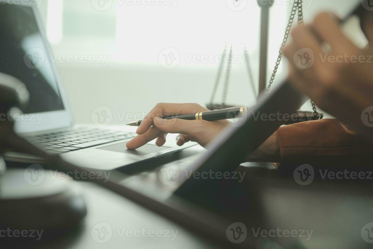 Business and lawyers discussing contract papers with brass scale on desk in office. Law, legal services, advice, justice and law concept picture with film grain effect photo
