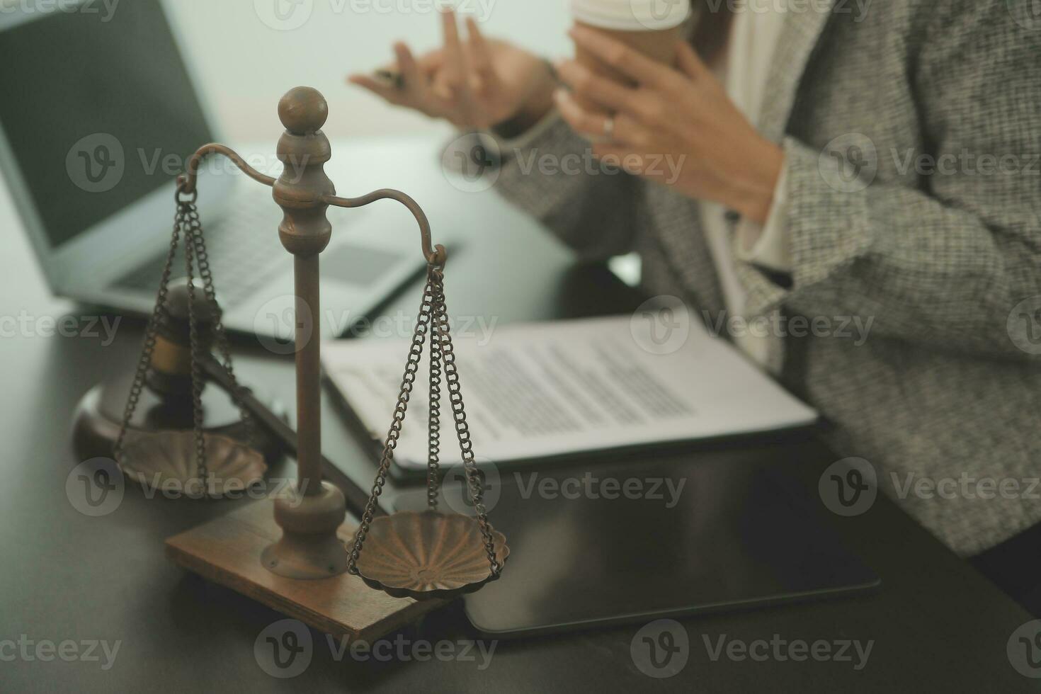 Business and lawyers discussing contract papers with brass scale on desk in office. Law, legal services, advice, justice and law concept picture with film grain effect photo