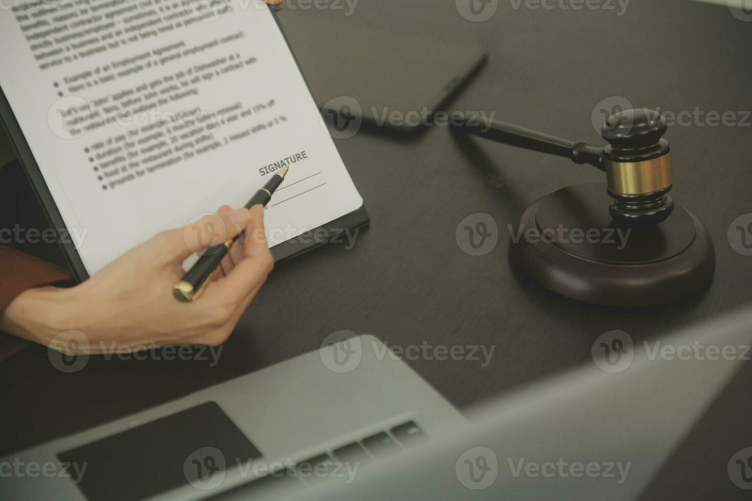 Business and lawyers discussing contract papers with brass scale on desk in office. Law, legal services, advice, justice and law concept picture with film grain effect photo