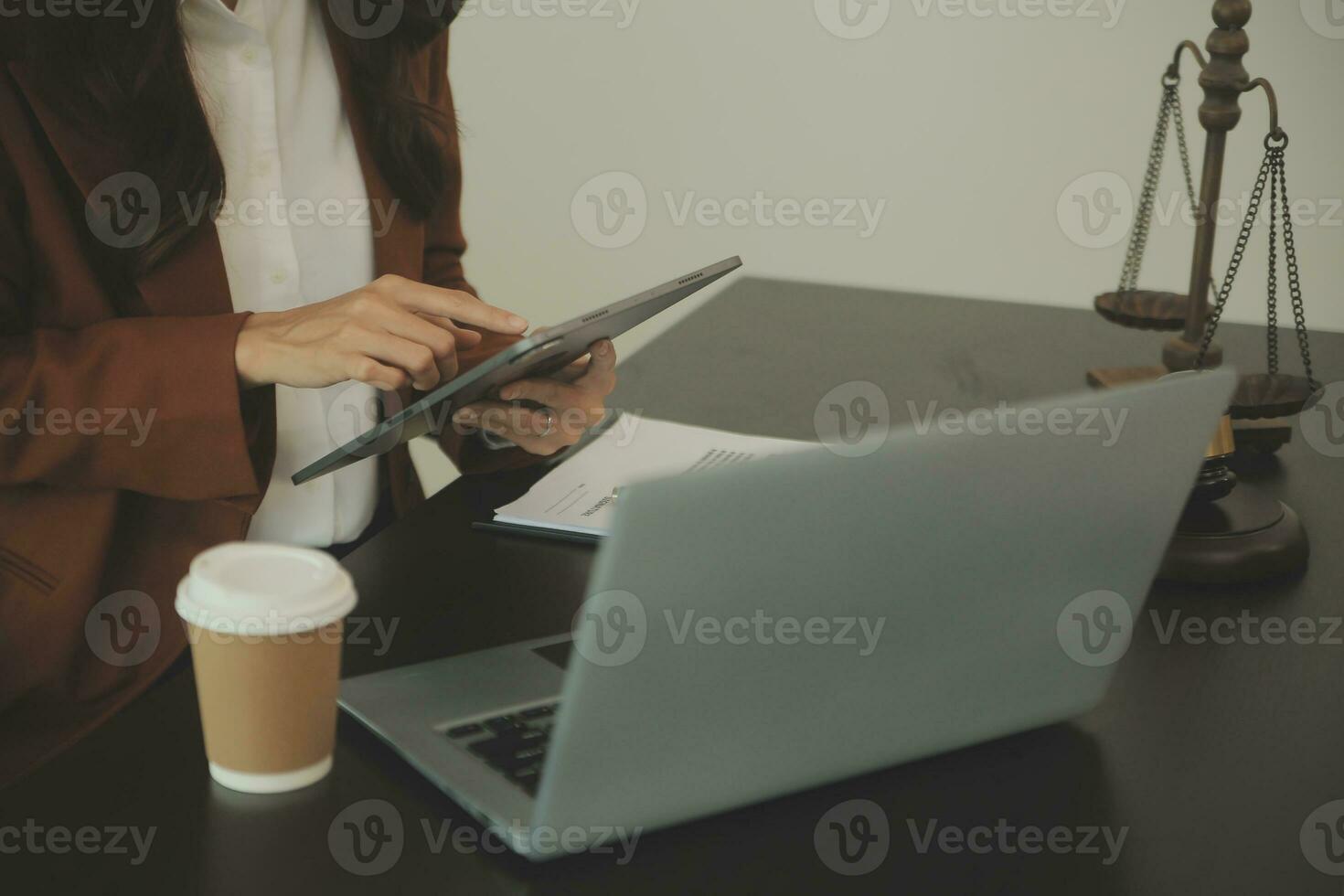 Business and lawyers discussing contract papers with brass scale on desk in office. Law, legal services, advice, justice and law concept picture with film grain effect photo