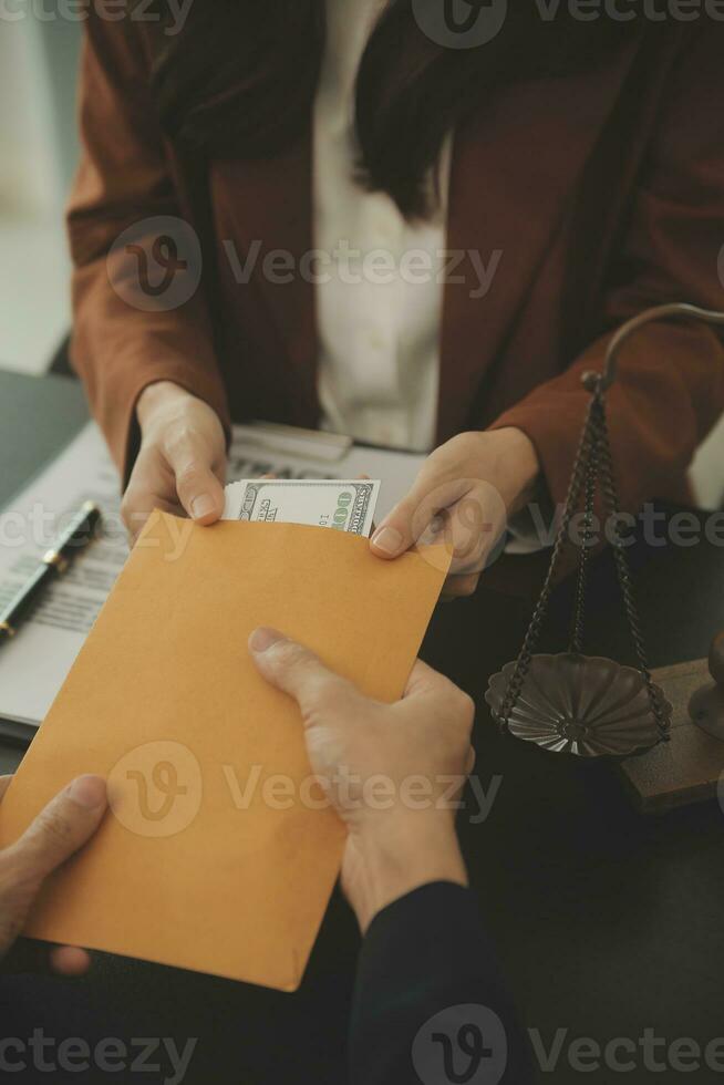 Business and lawyers discussing contract papers with brass scale on desk in office. Law, legal services, advice, justice and law concept picture with film grain effect photo