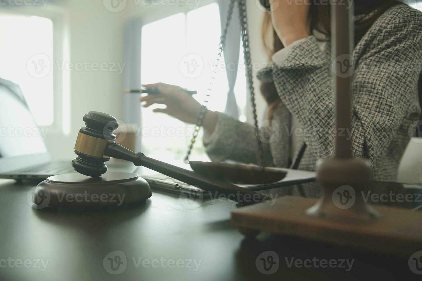 Business and lawyers discussing contract papers with brass scale on desk in office. Law, legal services, advice, justice and law concept picture with film grain effect photo