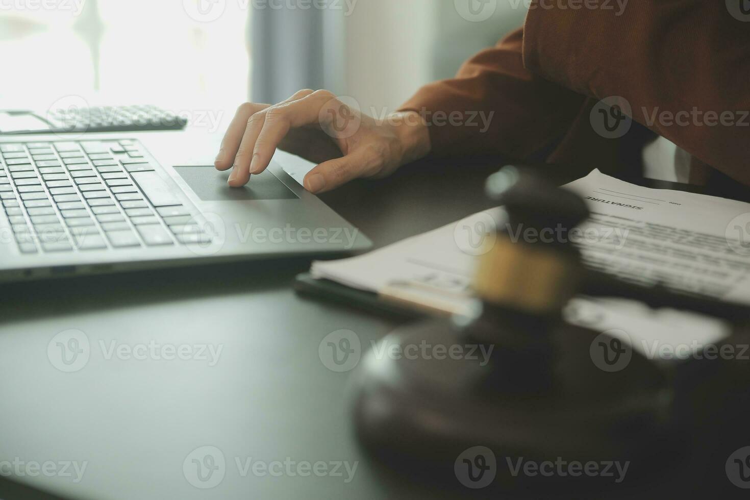 Business and lawyers discussing contract papers with brass scale on desk in office. Law, legal services, advice, justice and law concept picture with film grain effect photo