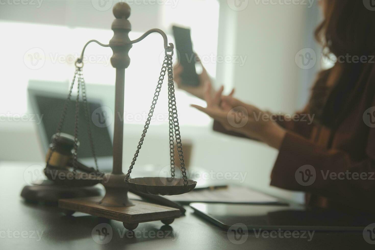 Business and lawyers discussing contract papers with brass scale on desk in office. Law, legal services, advice, justice and law concept picture with film grain effect photo