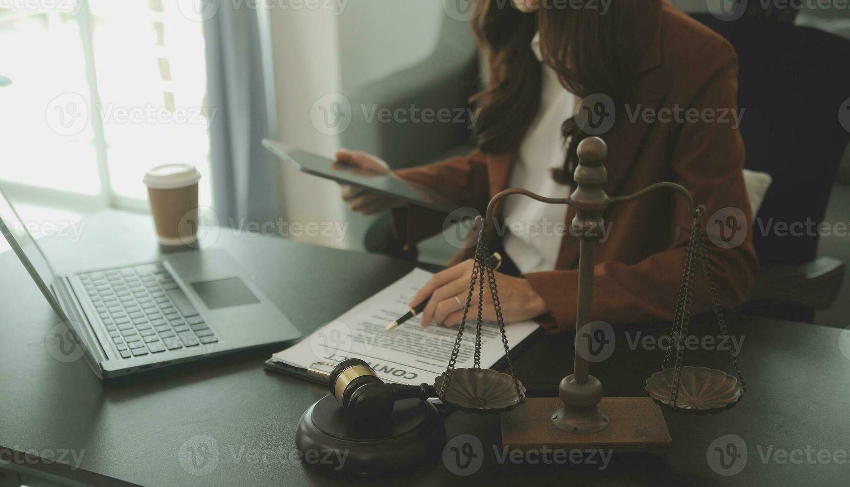 Business and lawyers discussing contract papers with brass scale on desk in office. Law, legal services, advice, justice and law concept picture with film grain effect photo