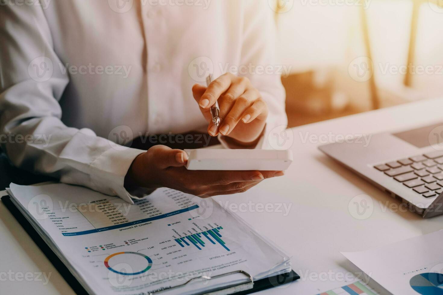 businessman working on desk office with using a calculator to calculate the numbers, finance accounting concept photo