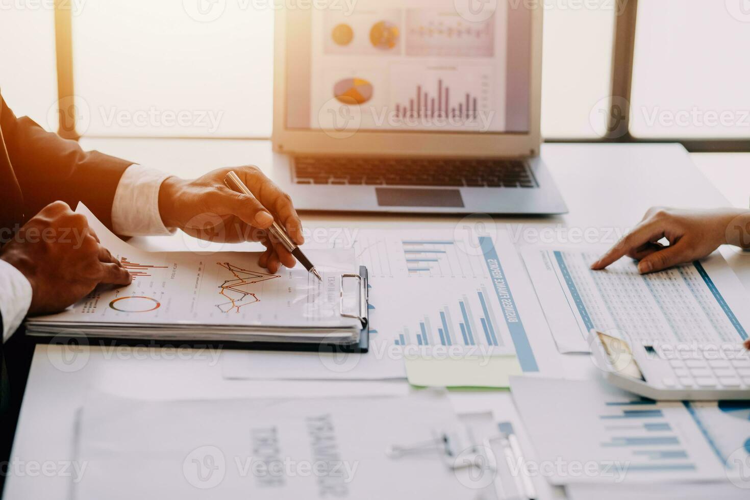businessman working on desk office with using a calculator to calculate the numbers, finance accounting concept photo