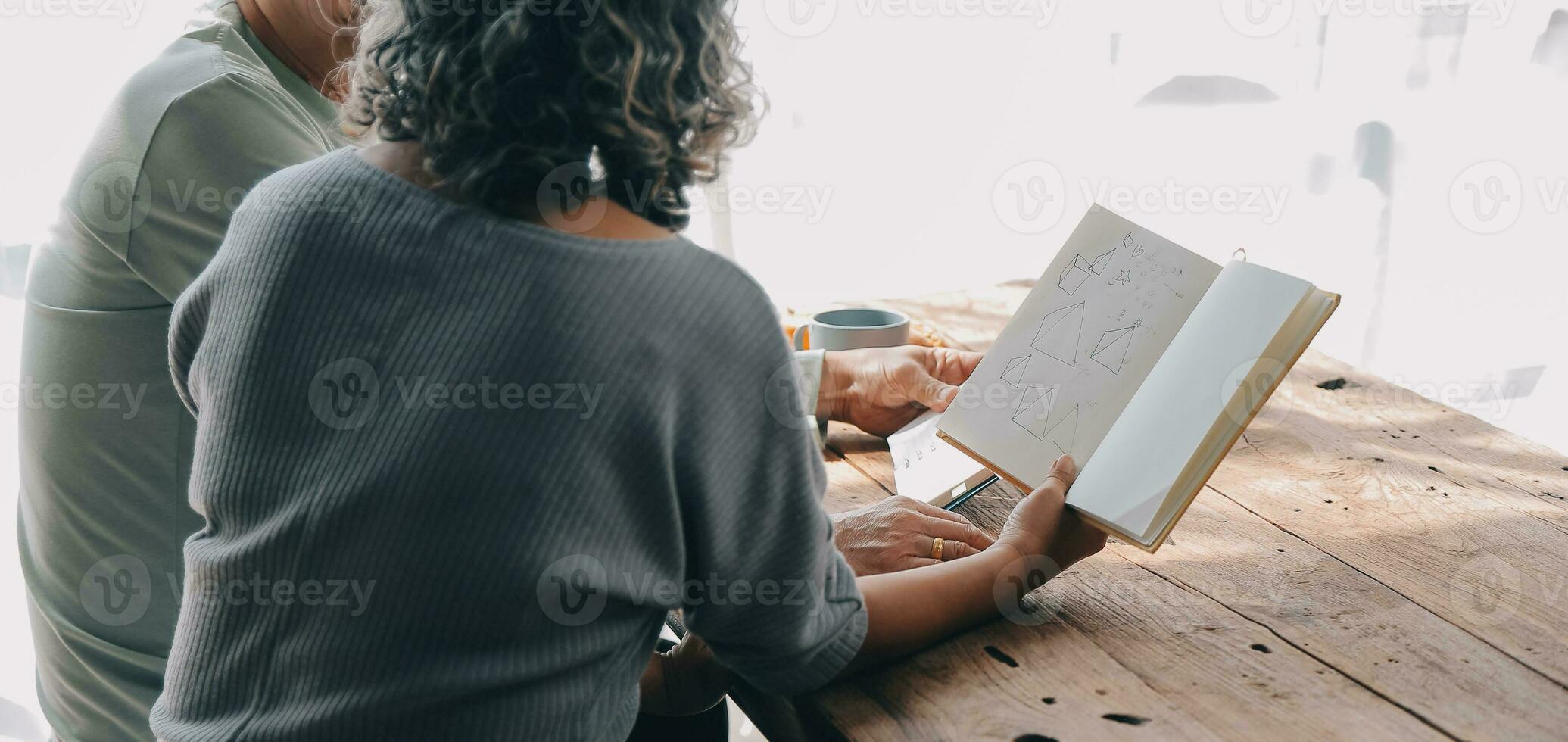 Embraced mature couple surfing the Internet on laptop at home photo