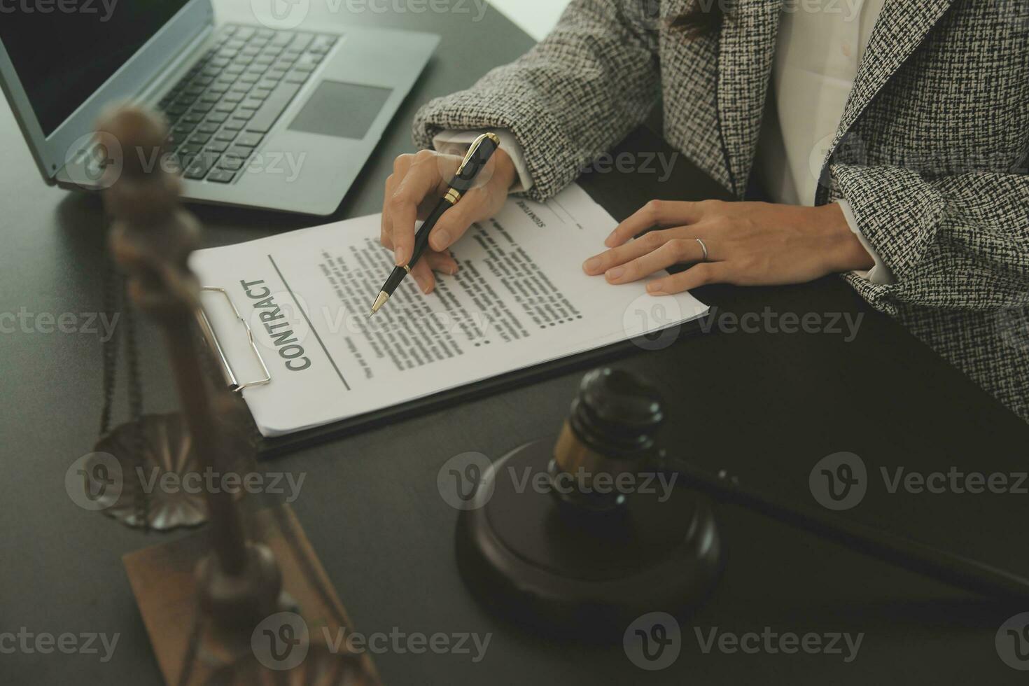 Business and lawyers discussing contract papers with brass scale on desk in office. Law, legal services, advice, justice and law concept picture with film grain effect photo