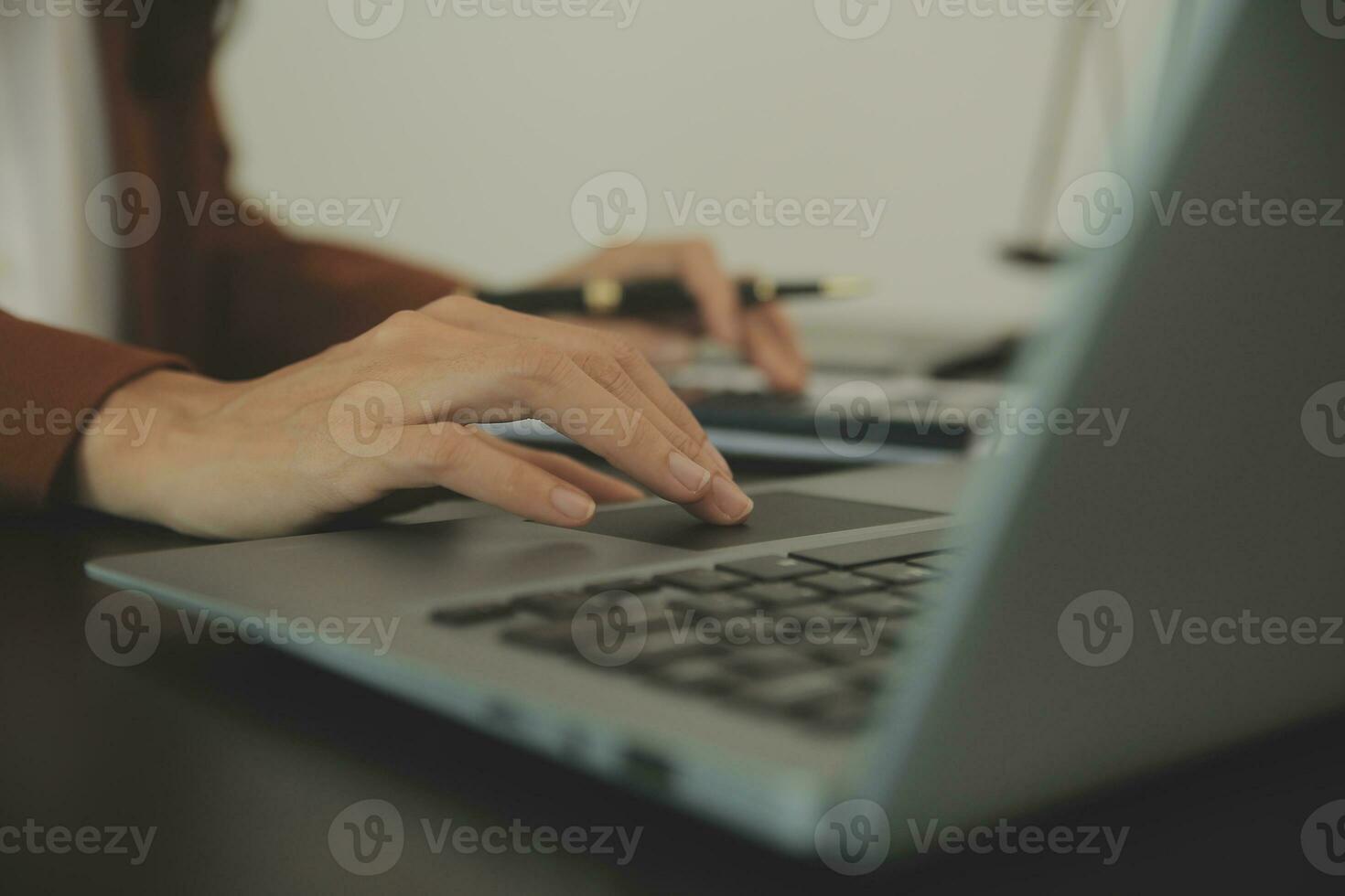 Business and lawyers discussing contract papers with brass scale on desk in office. Law, legal services, advice, justice and law concept picture with film grain effect photo