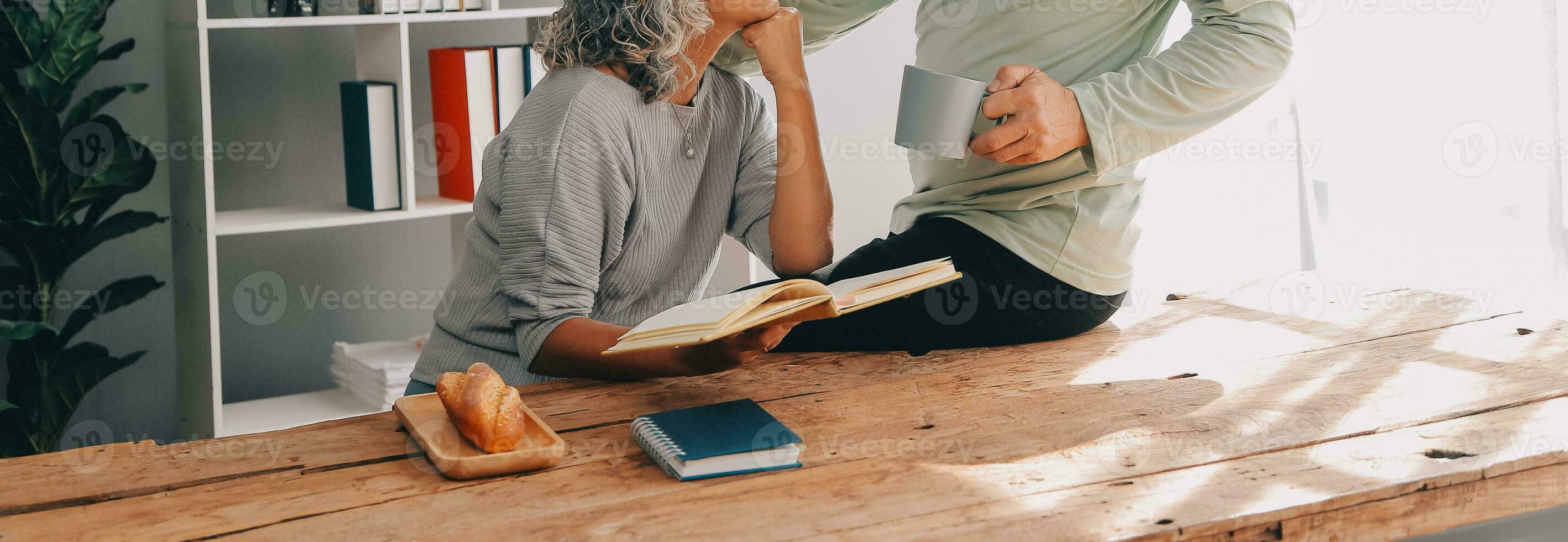 Embraced mature couple surfing the Internet on laptop at home photo