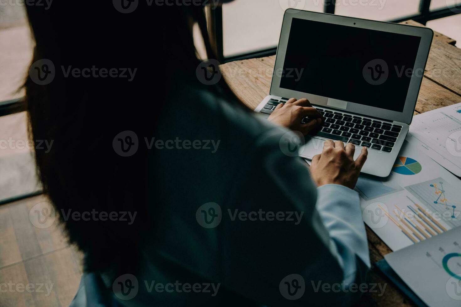 Attractive smiling young asian business woman work at home office, Asian woman working on laptop computer holding tablet. photo