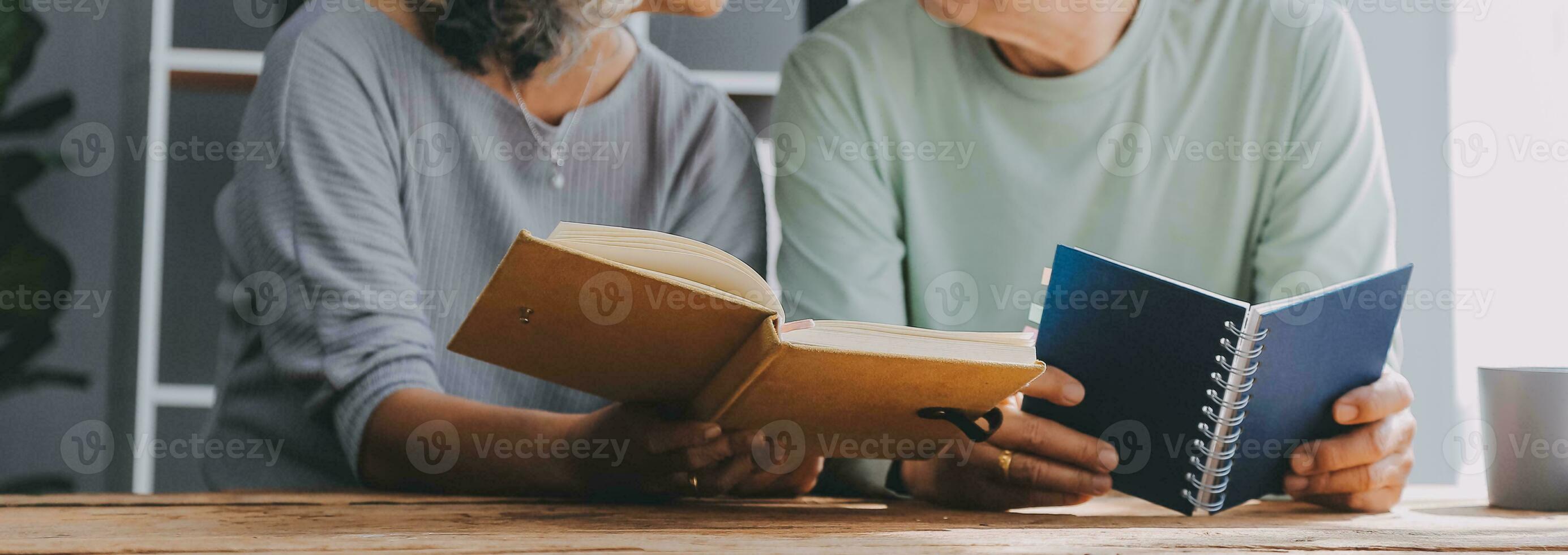 Happy mature couple using laptop at home photo