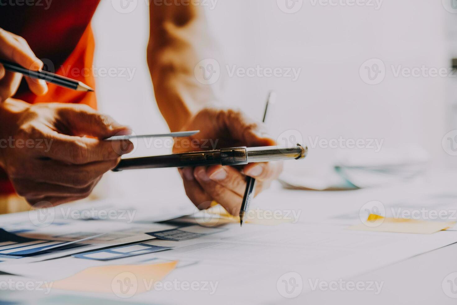 Close up ux developer and ui designer brainstorming about mobile app interface wireframe design on table with customer breif and color code at modern office.Creative digital development agency photo