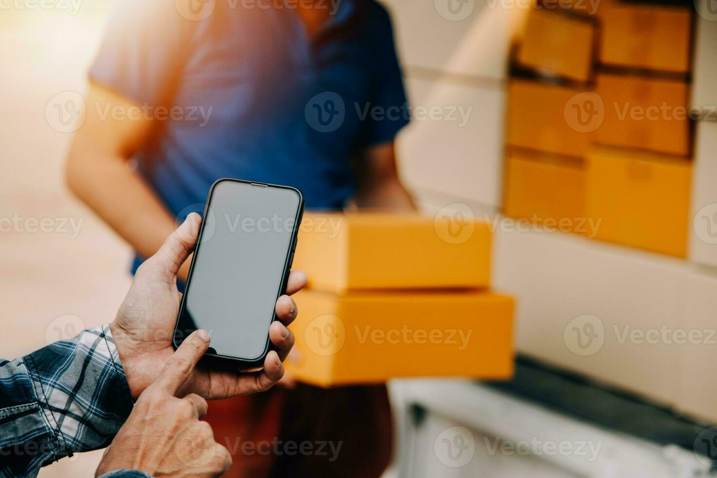 Entrepreneurs Small Business SME Independent men work at home Use smartphones and laptops for commercial checking, online marketing, packing boxes, SME sellers, concept, e-commerce team, online sales photo