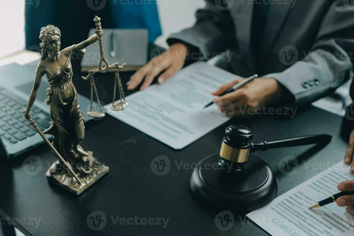 Business and lawyers discussing contract papers with brass scale on desk in office. Law, legal services, advice, justice and law concept picture with film grain effect photo