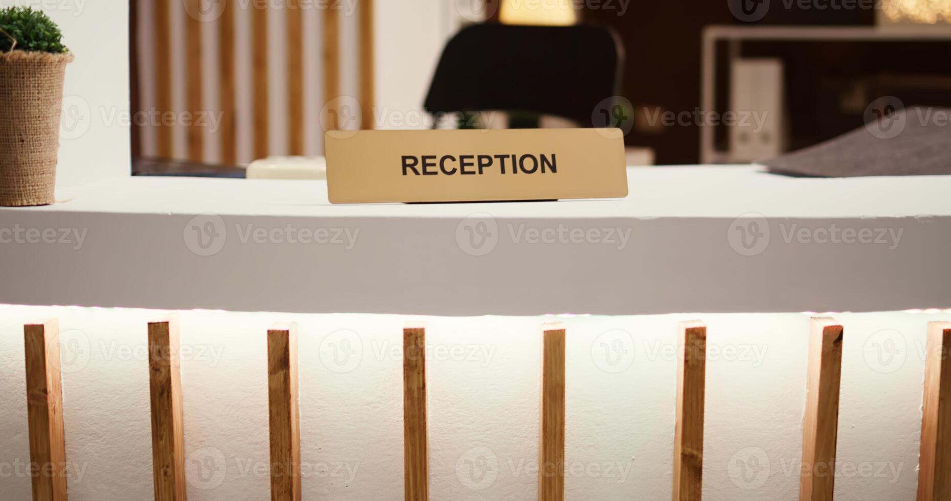 Reveal of reception sign travel accommodation hotel lobby modern clean reception counter. Empty hospitality industry check in front desk in stylish luxurious resort lounge interior photo