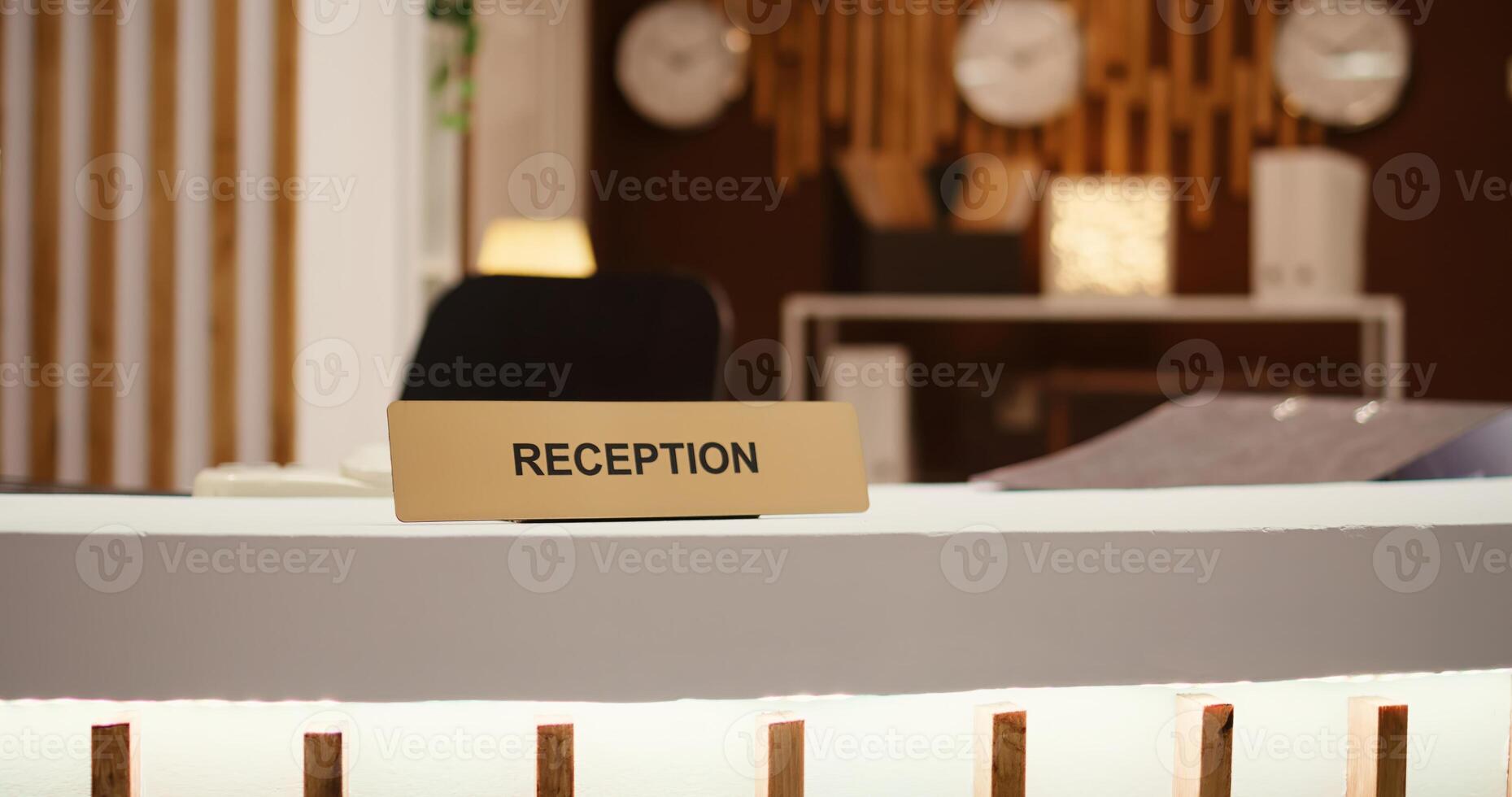 Close up shot of hospitality industry hotel lobby modern clean reception front desk. Empty travel accommodation check in counter in stylish luxurious resort lounge interior photo