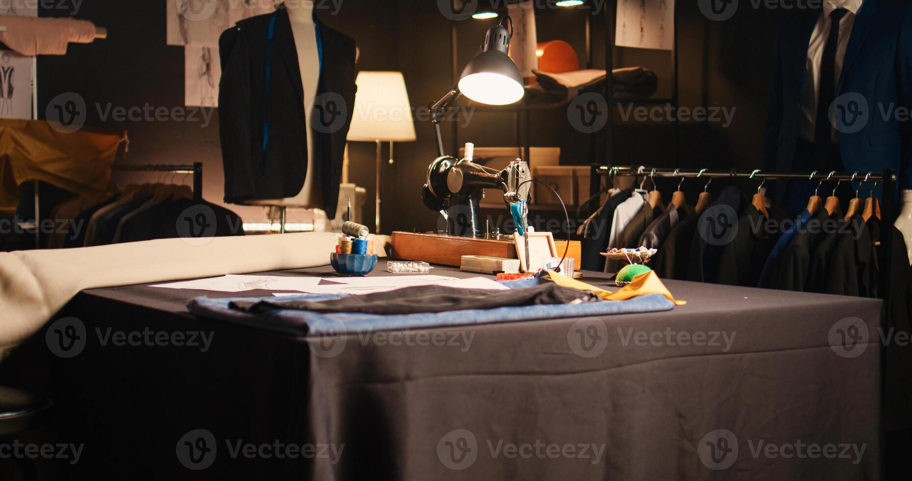 Empty fashion atelier with tailor tools, handcraft and textile industry workshop with industrial instruments. Luxury atelier with sketches designs of items and needlework equipment. photo