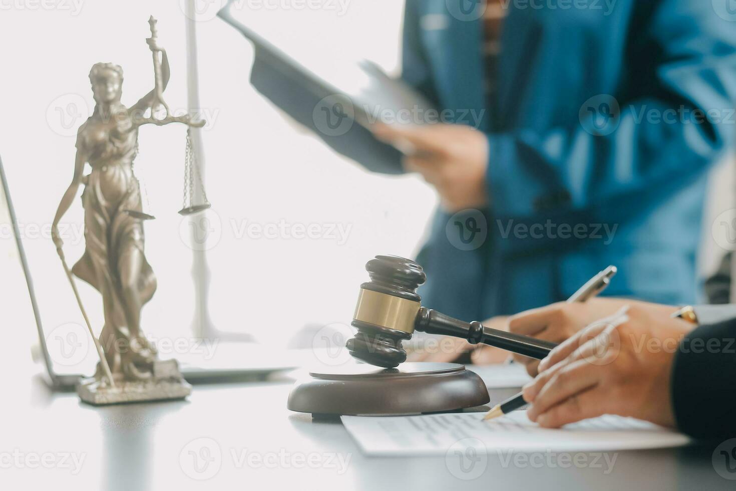Business and lawyers discussing contract papers with brass scale on desk in office. Law, legal services, advice, justice and law concept picture with film grain effect photo