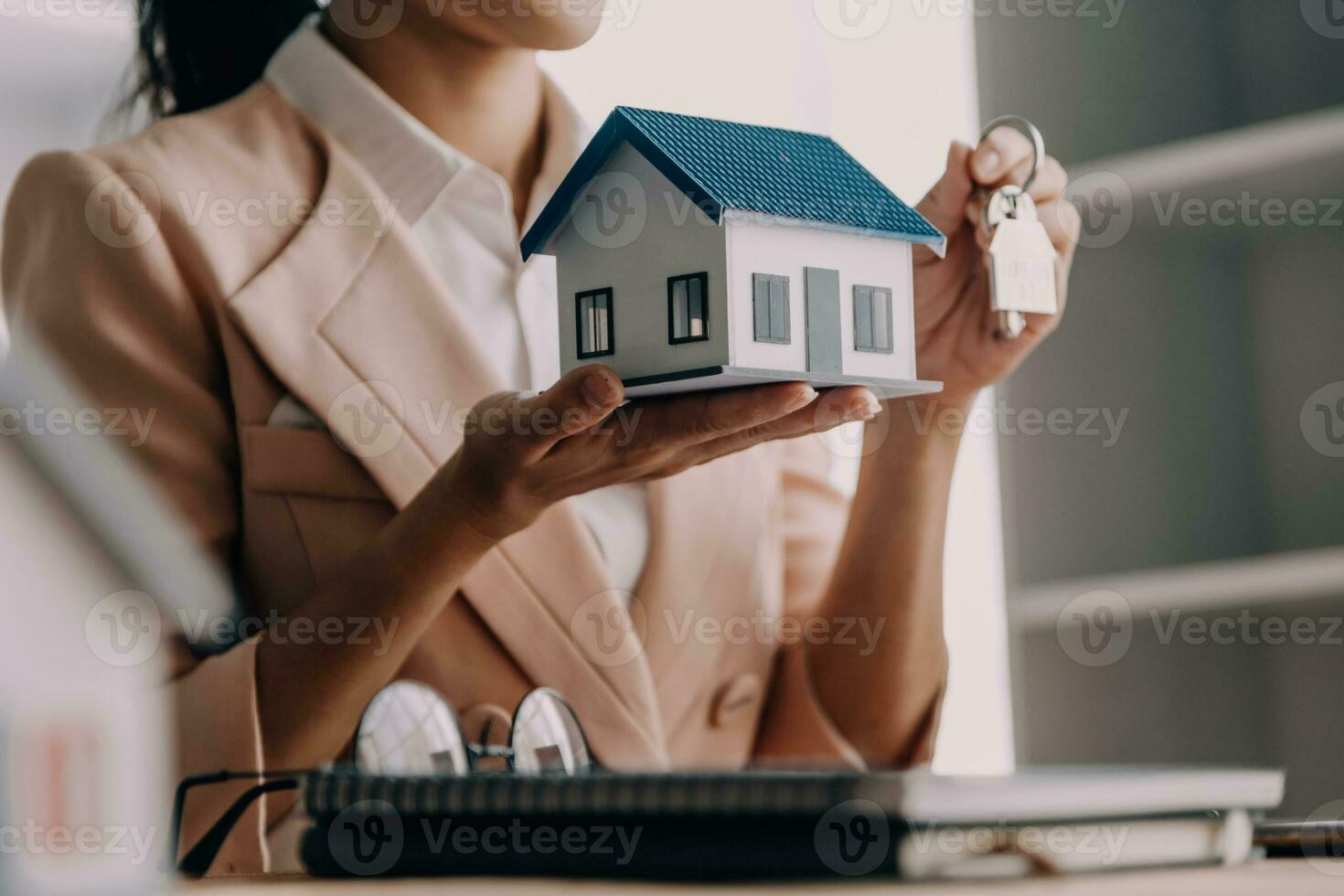 Real estate brokerage agent Deliver a sample of a model house to the customer, mortgage loan agreement Making lease and buying a house And contract home insurance concept photo