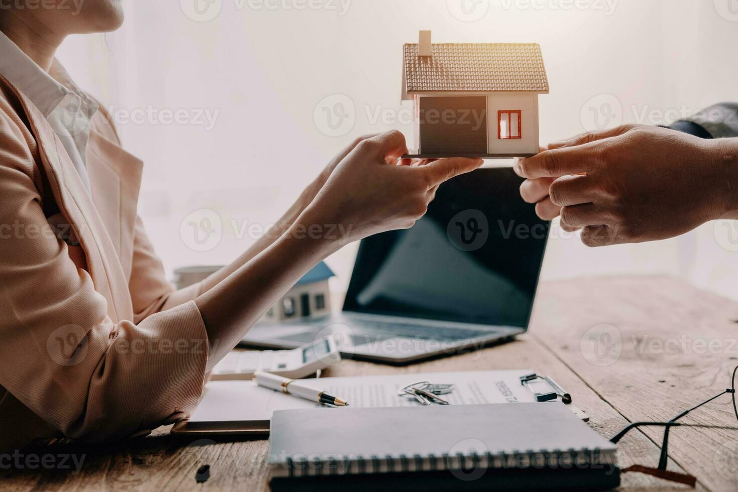 Real estate brokerage agent Deliver a sample of a model house to the customer, mortgage loan agreement Making lease and buying a house And contract home insurance concept photo