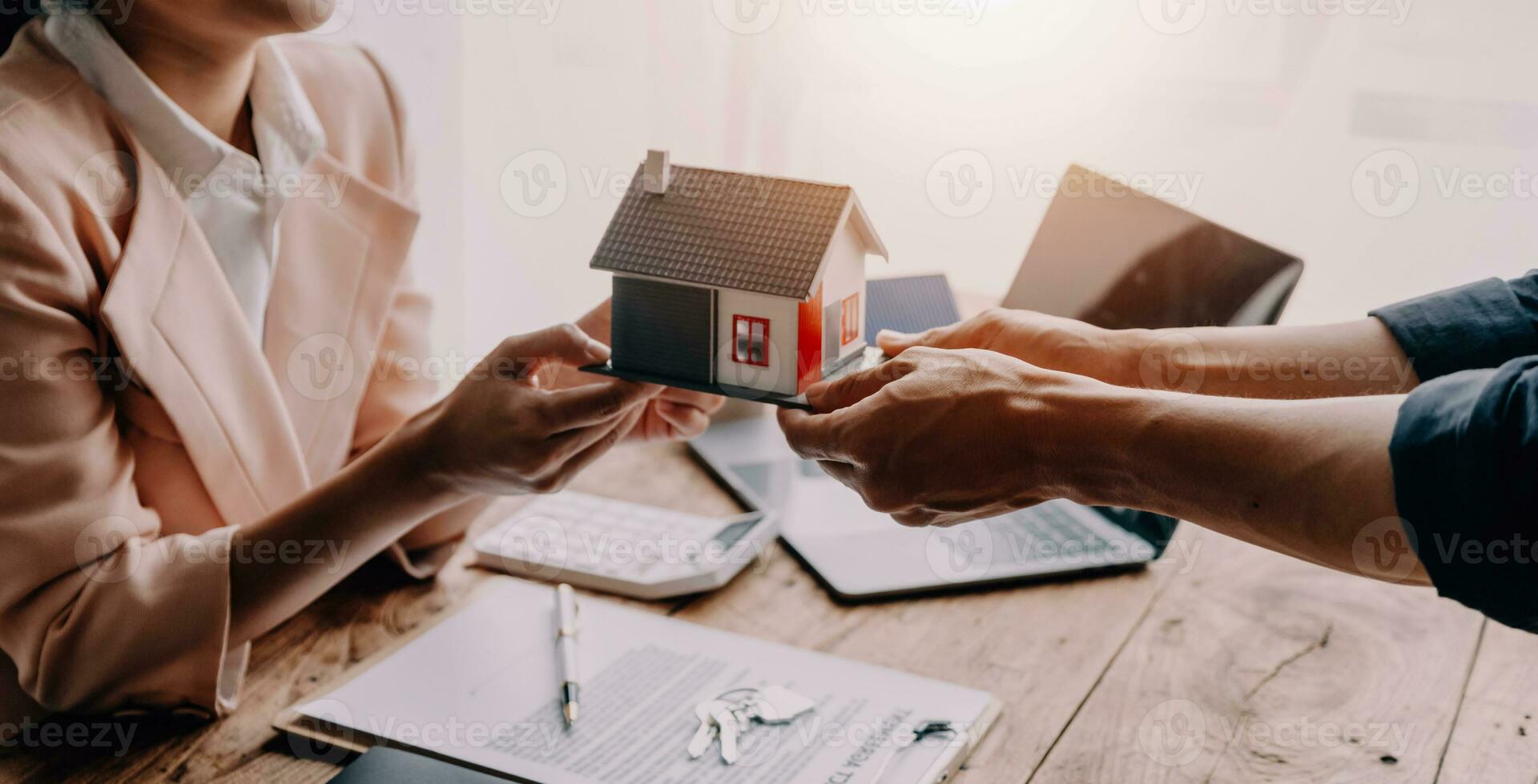 Real estate brokerage agent Deliver a sample of a model house to the customer, mortgage loan agreement Making lease and buying a house And contract home insurance concept photo