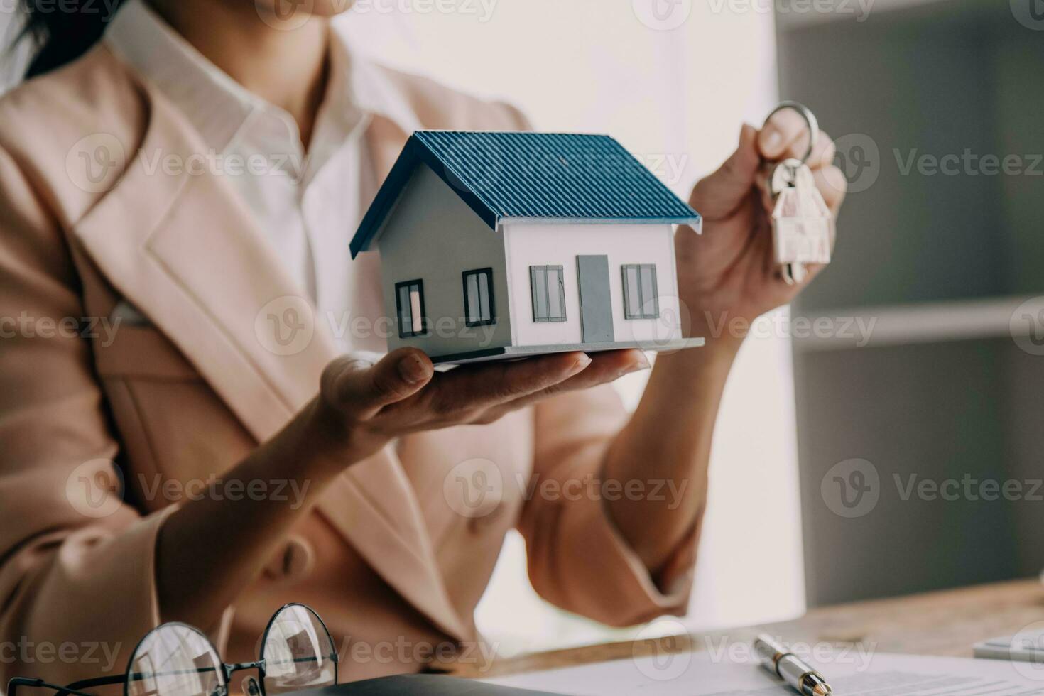 Real estate brokerage agent Deliver a sample of a model house to the customer, mortgage loan agreement Making lease and buying a house And contract home insurance concept photo