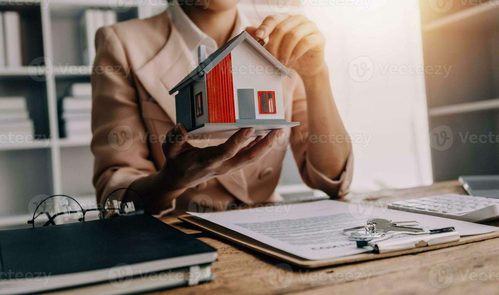 Real estate brokerage agent Deliver a sample of a model house to the customer, mortgage loan agreement Making lease and buying a house And contract home insurance concept photo